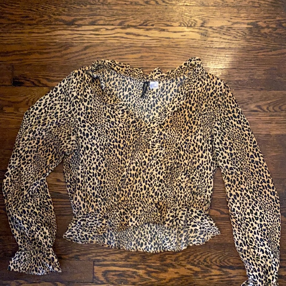H&M divided cheetah print blouse with ruffle detail. Size 8.